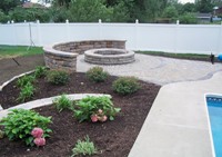 Paving bricks used around a swimming pool and to highlight a garden